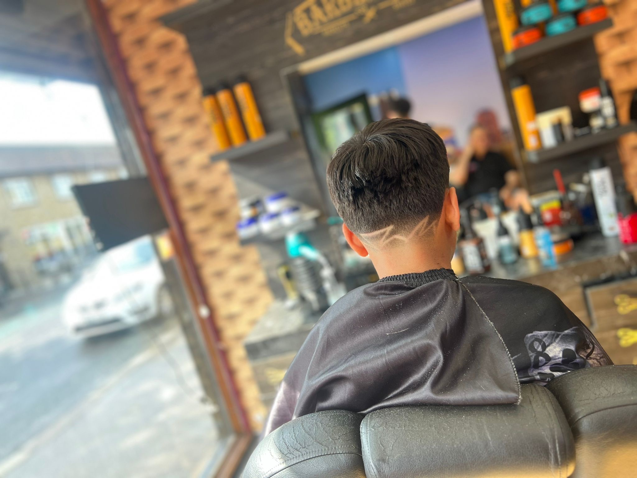 A finished haircut with a shaved pattern, photographed inside Otley barber