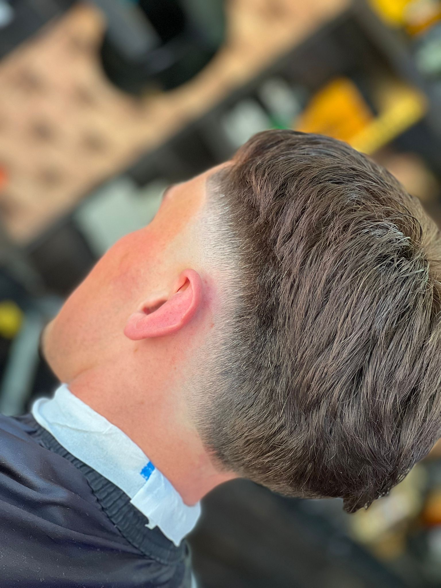 Close side view of a finished short haircut at Otley barber