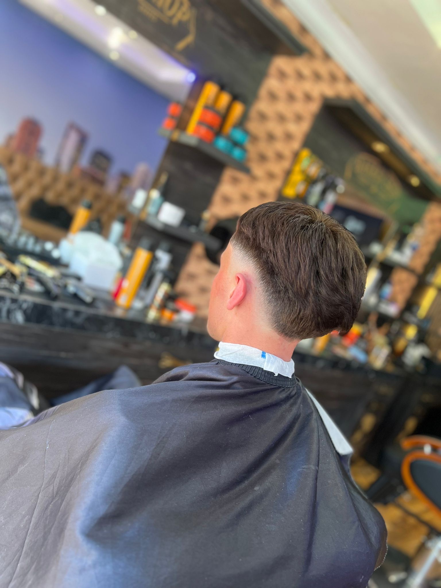 A longer finished haircut photographed from behind in the shop