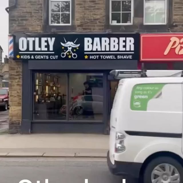 The Otley barber shopfront at 5 Crossgate, with its white lettering and scissors sign